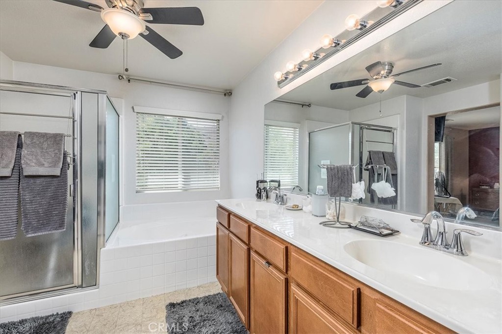 28984 Escalante Road Menifee, CA 92587 - Photo 18 of 40 Primary bathroom with separate tub and shower and double sink vanity