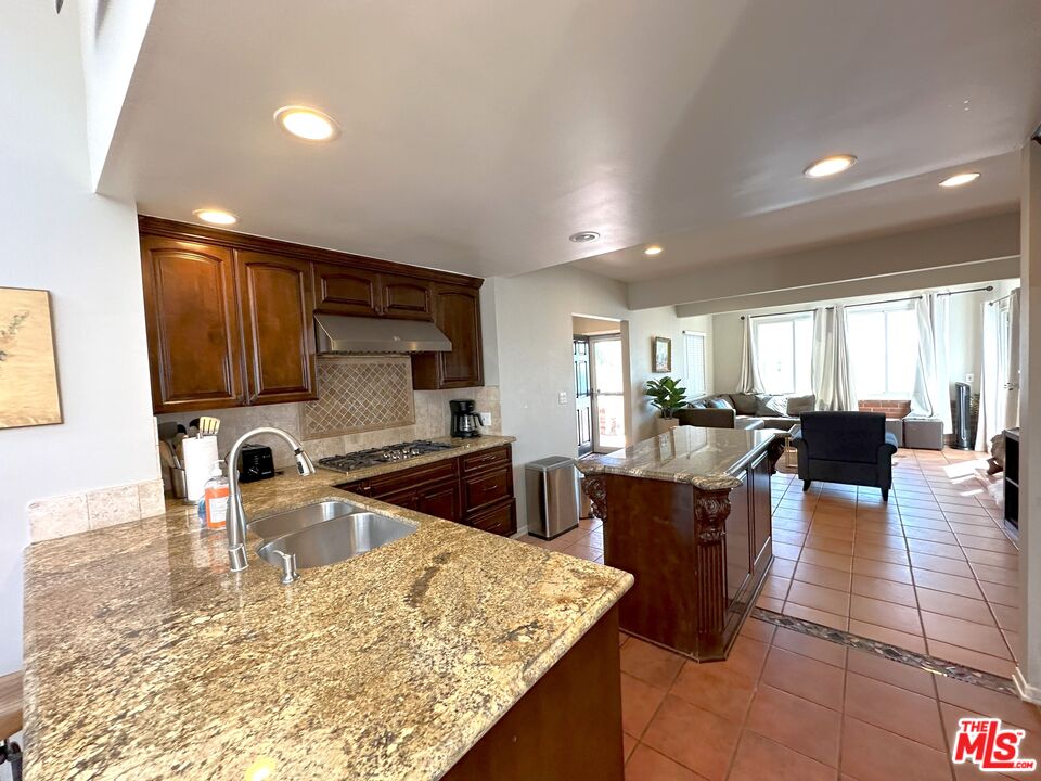 135 Napoleon Street Playa del Rey, CA 90293 - Photo 12 of 36 a kitchen with a stove a sink a counter space and dining table