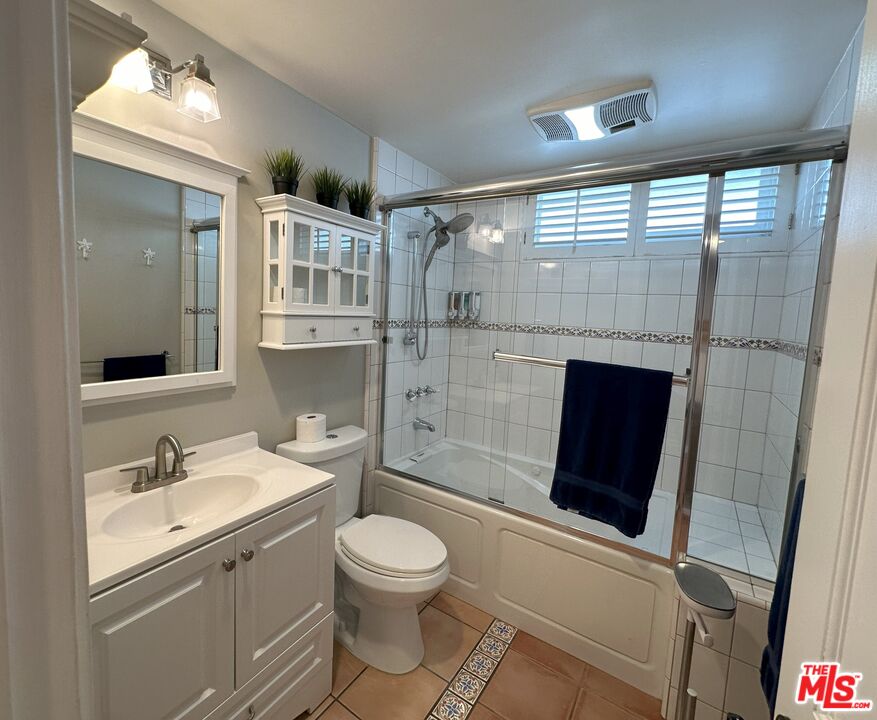 135 Napoleon Street Playa del Rey, CA 90293 - Photo 15 of 36 a bathroom with a toilet a sink and glass door