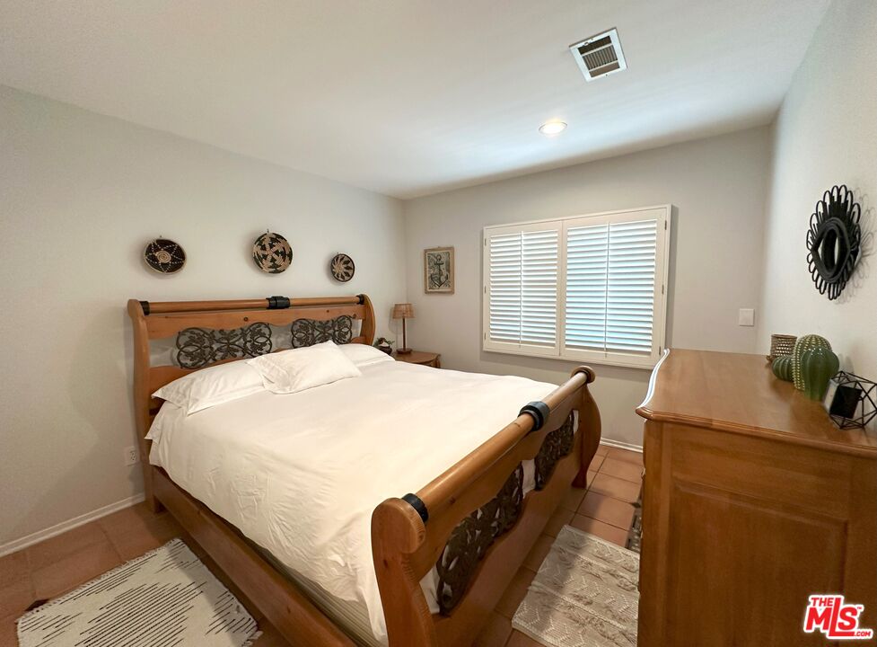 135 Napoleon Street Playa del Rey, CA 90293 - Photo 16 of 36 a bed sitting in a bedroom next to a window with pc on the wall