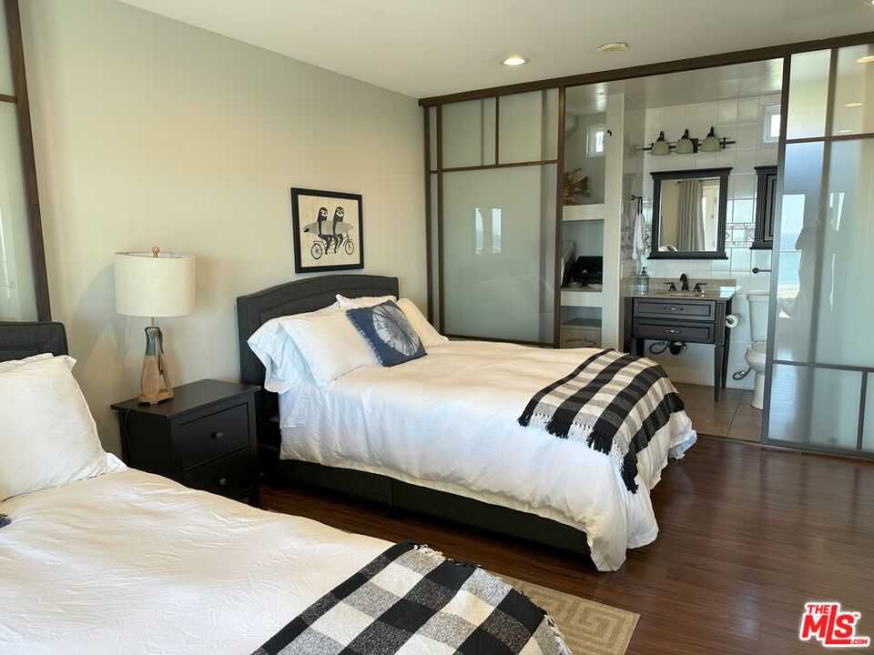 135 Napoleon Street Playa del Rey, CA 90293 - Photo 32 of 36 a bedroom with a bed and wooden floor
