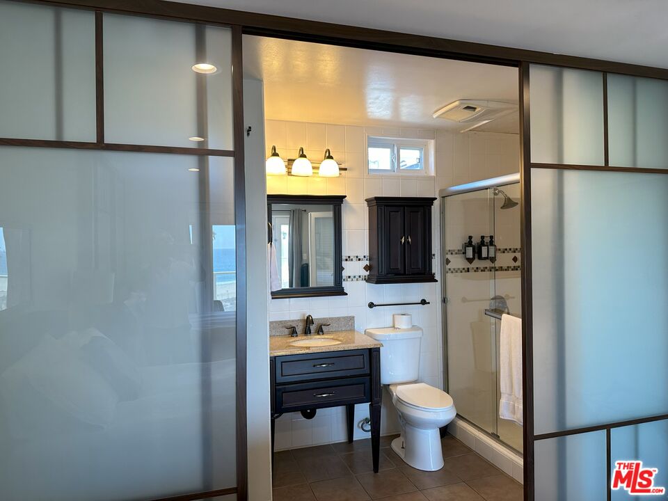 135 Napoleon Street Playa del Rey, CA 90293 - Photo 33 of 36 a bathroom with a toilet a sink and a mirror