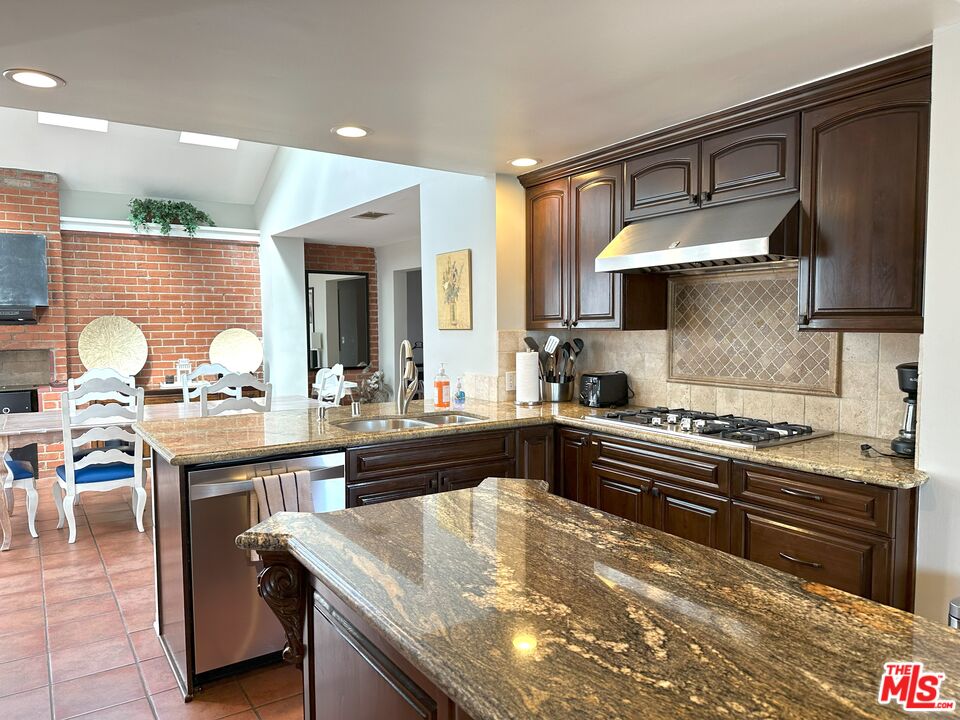 135 Napoleon Street Playa del Rey, CA 90293 - Photo 9 of 36 a kitchen with granite countertop a sink stove and cabinets