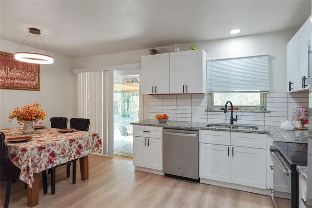 a kitchen with a sink cabinets and wooden floor