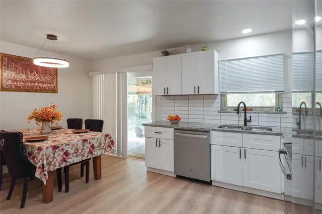 a kitchen with a sink cabinets and wooden floor