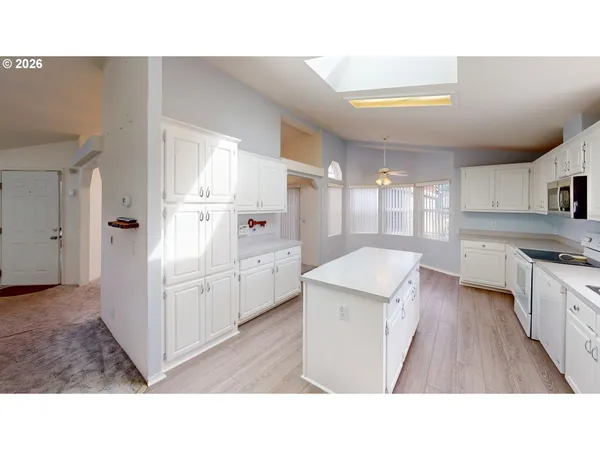a open kitchen with sink and cabinets