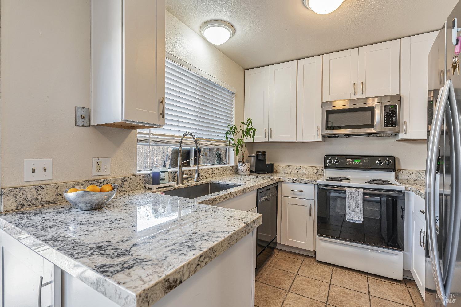 1015 Golf Course Drive Rohnert Park, CA 94928 - Photo 1 of 1 a kitchen with stainless steel appliances granite countertop a sink stove and refrigerator