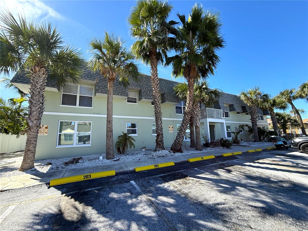 14120 Palm Street, Unit 104 Madeira Beach, FL 33708 - Photo 1 of 18 a view of a house with swimming pool and sitting area