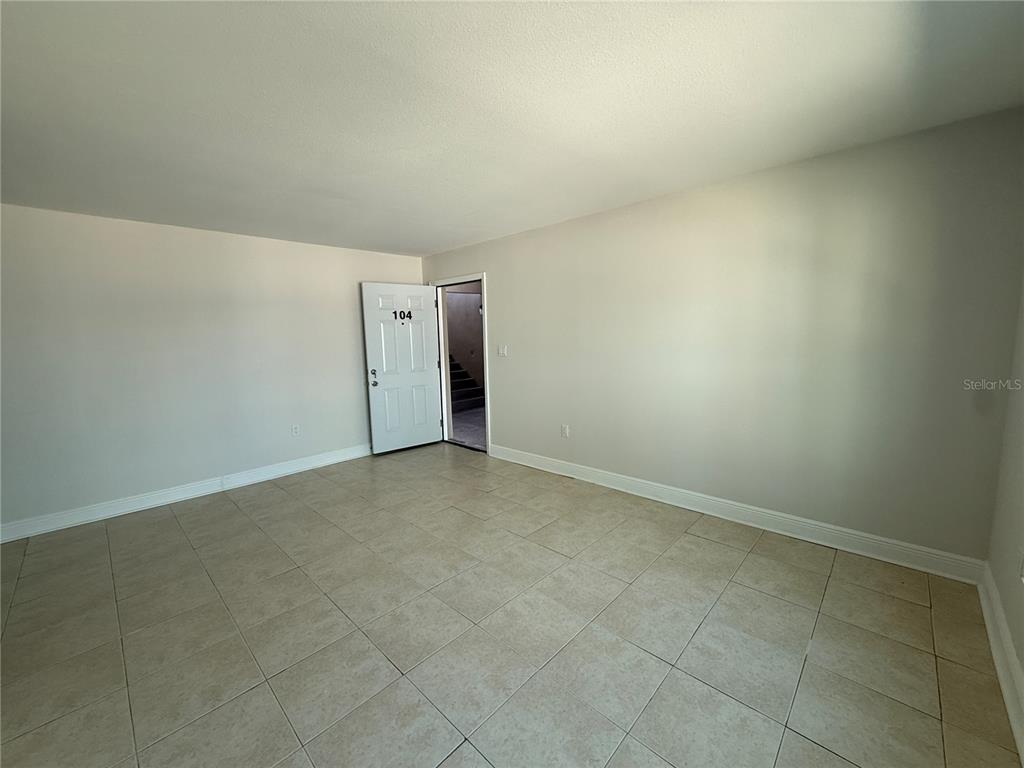 14120 Palm Street, Unit 104 Madeira Beach, FL 33708 - Photo 3 of 18 a view of an empty room and entrance