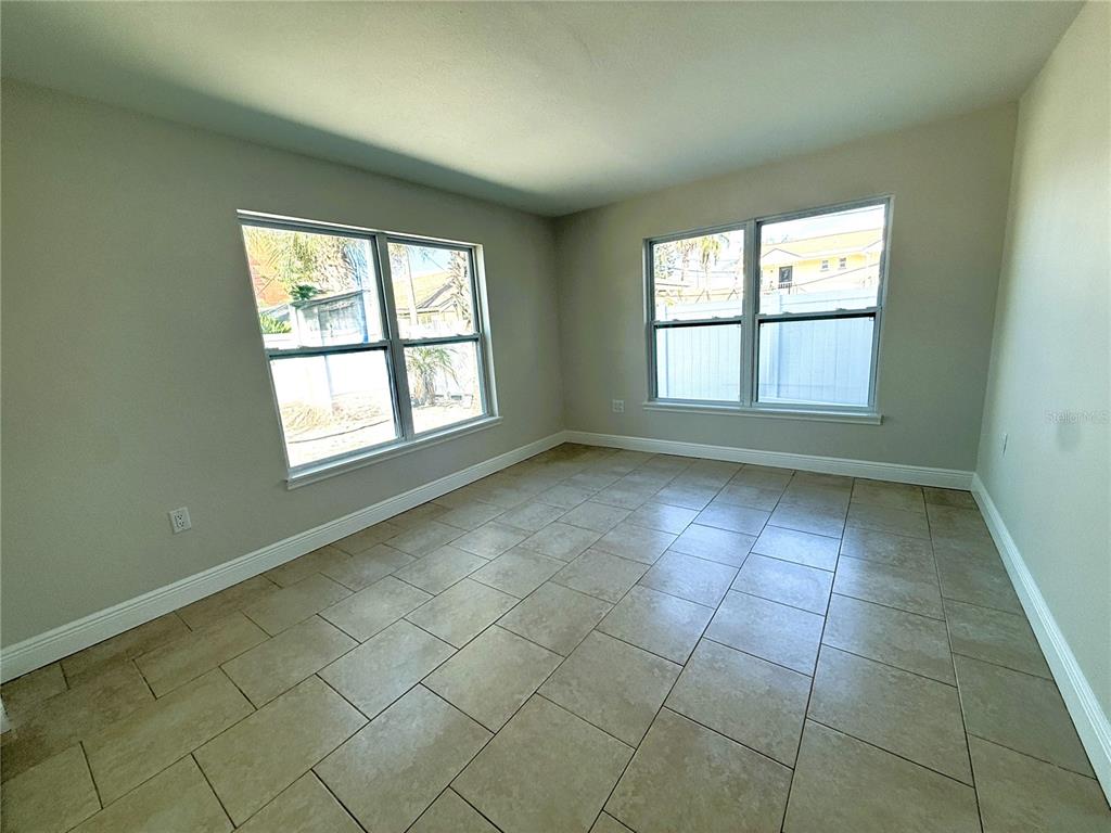 14120 Palm Street, Unit 104 Madeira Beach, FL 33708 - Photo 6 of 18 an empty room with windows