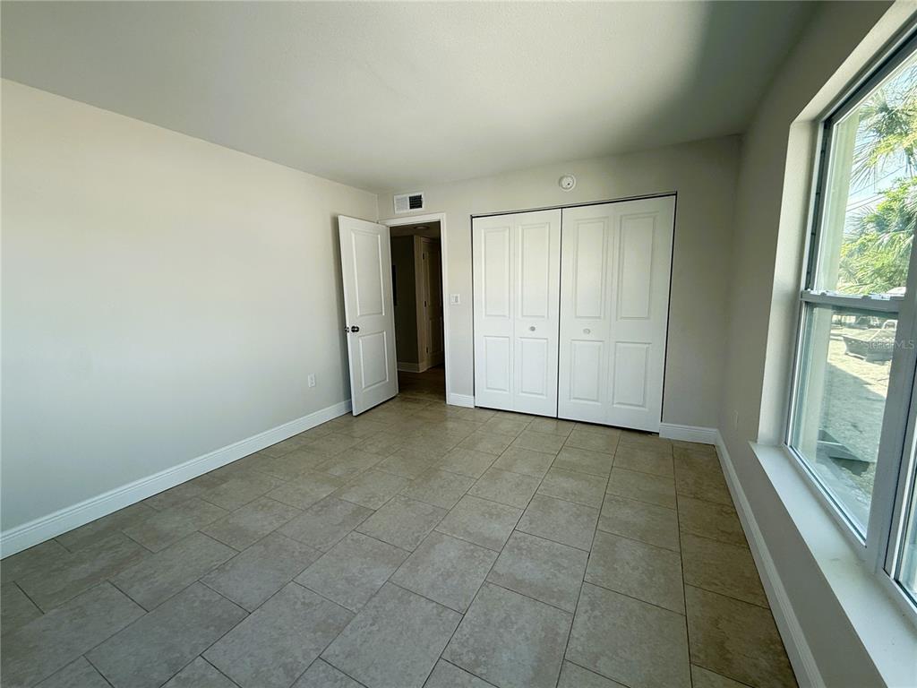 14120 Palm Street, Unit 104 Madeira Beach, FL 33708 - Photo 7 of 18 an empty room with windows