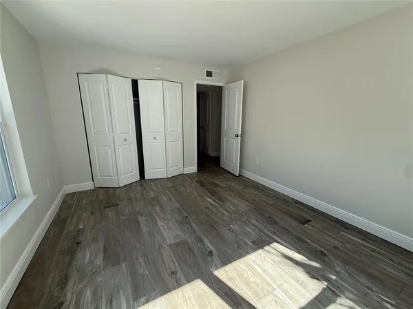 a view of an empty room and wooden floor