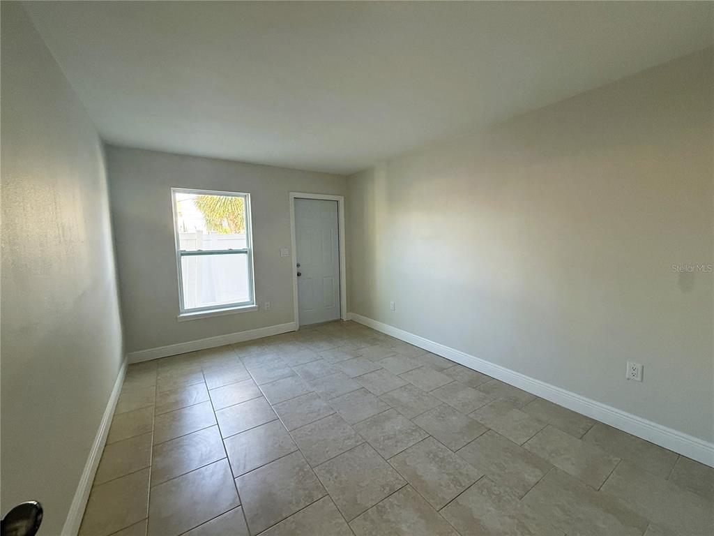 14120 Palm Street, Unit 104 Madeira Beach, FL 33708 - Photo 9 of 18 an empty room with a bathroom and a window