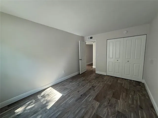 a view of wooden floor and windows in a room