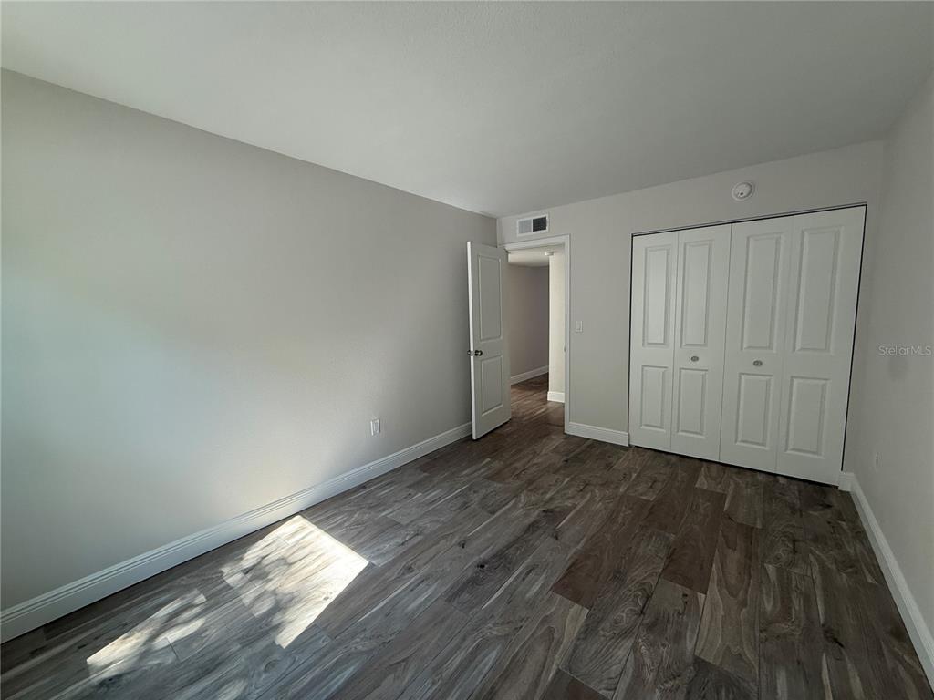 14120 Palm Street, Unit 103 Madeira Beach, FL 33708 - Photo 9 of 19 a view of wooden floor and windows in a room