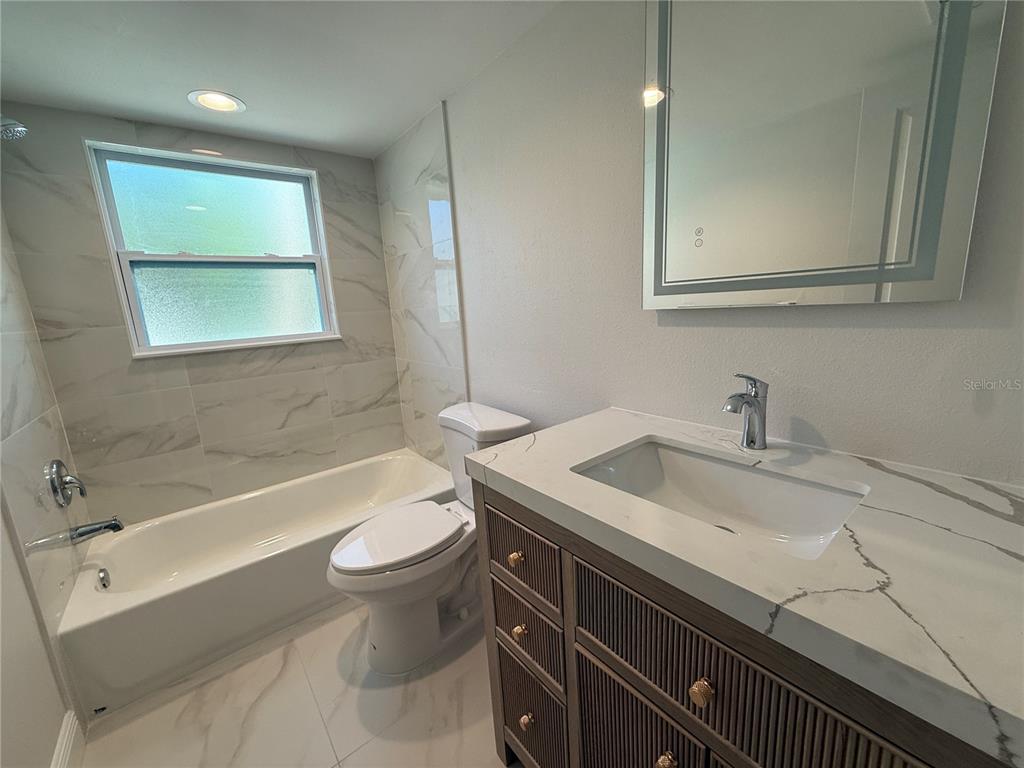 14120 Palm Street, Unit 103 Madeira Beach, FL 33708 - Photo 10 of 19 a bathroom with a sink and a toilet
