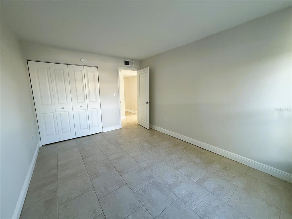 14120 Palm Street, Unit 104 Madeira Beach, FL 33708 - Photo 10 of 18 an empty room with a natural light