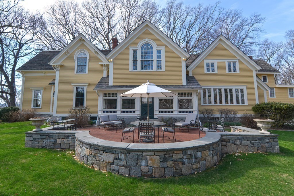 202 Paine Street Bellingham, MA 02019 - Photo 1 of 42 a front view of a house with a yard table and chairs