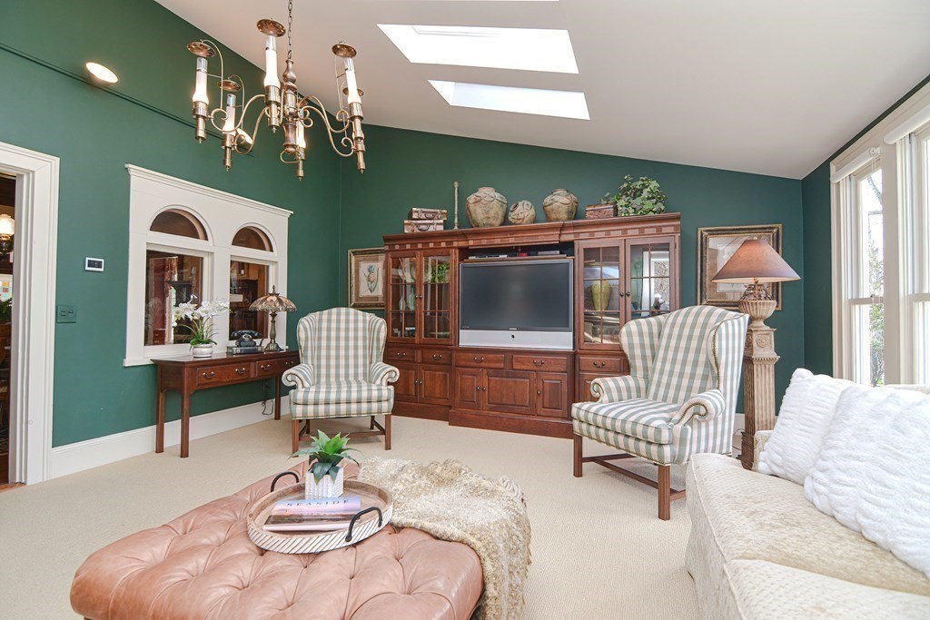 202 Paine Street Bellingham, MA 02019 - Photo 14 of 42 a living room with furniture chandelier and a fireplace