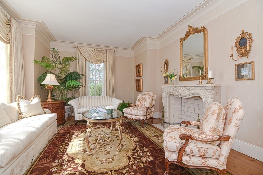 202 Paine Street Bellingham, MA 02019 - Photo 16 of 42 a living room with furniture a fireplace and a table