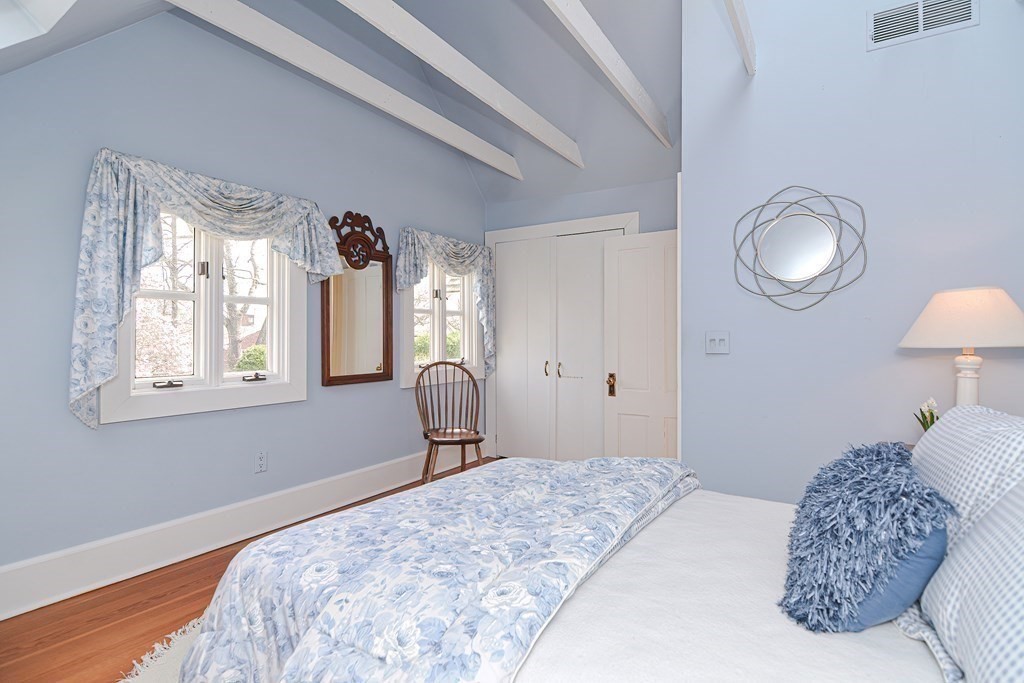 202 Paine Street Bellingham, MA 02019 - Photo 20 of 42 a bedroom with a bed mirror and a window