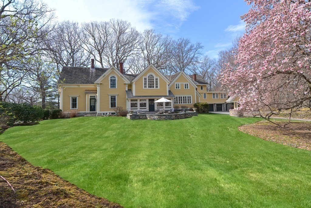 202 Paine Street Bellingham, MA 02019 - Photo 2 of 42 a front view of a house with a garden and trees