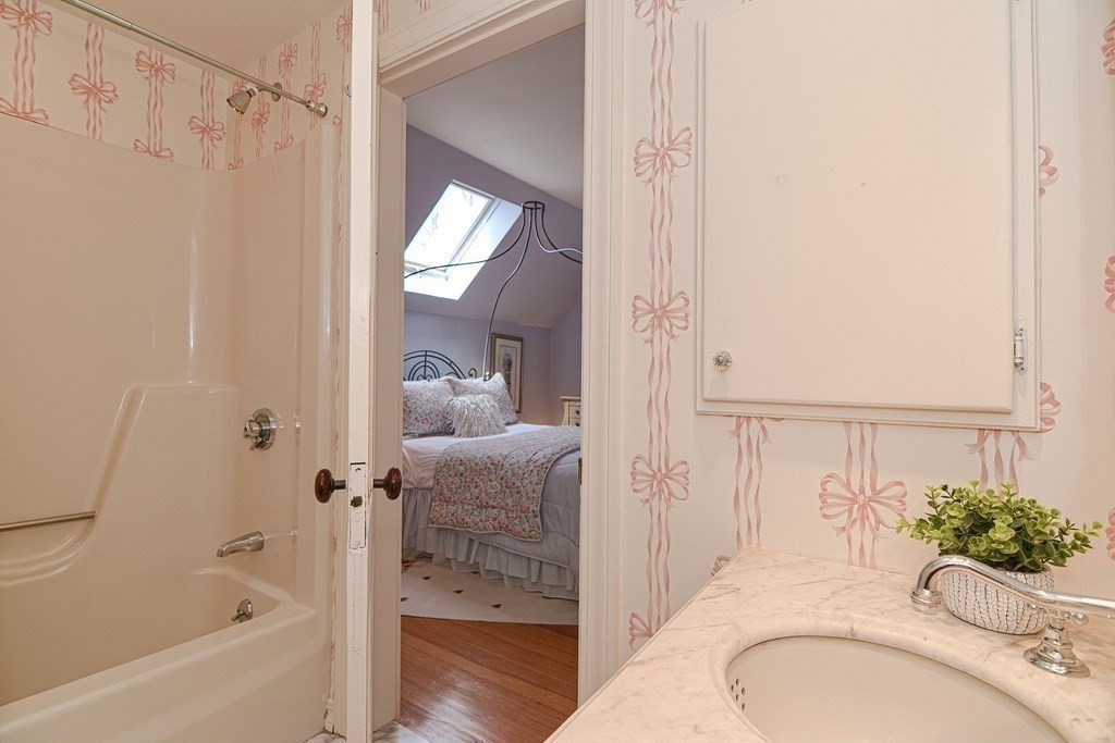 202 Paine Street Bellingham, MA 02019 - Photo 29 of 42 a bathroom with a granite countertop sink mirror and shower