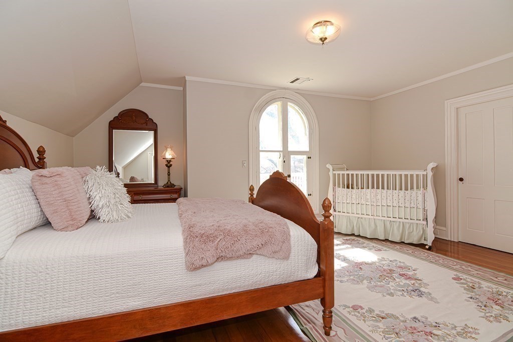 202 Paine Street Bellingham, MA 02019 - Photo 30 of 42 a bedroom with a bed and a window
