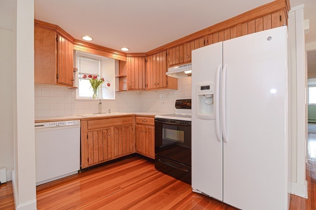 202 Paine Street Bellingham, MA 02019 - Photo 32 of 42 a kitchen with stainless steel appliances a refrigerator and a sink