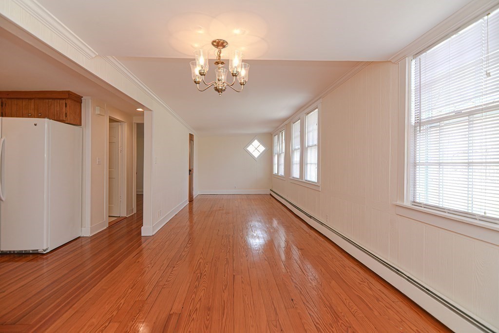 202 Paine Street Bellingham, MA 02019 - Photo 33 of 42 a view of an empty room with wooden floor and a window