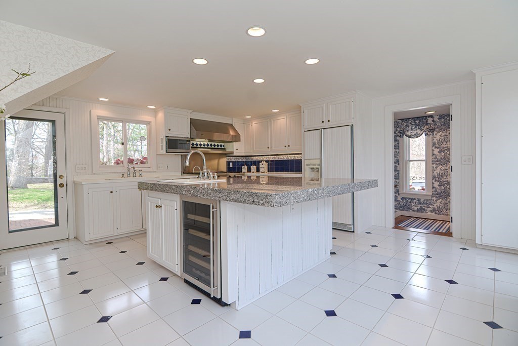 202 Paine Street Bellingham, MA 02019 - Photo 5 of 42 a kitchen with stainless steel appliances kitchen island granite countertop a sink and cabinets