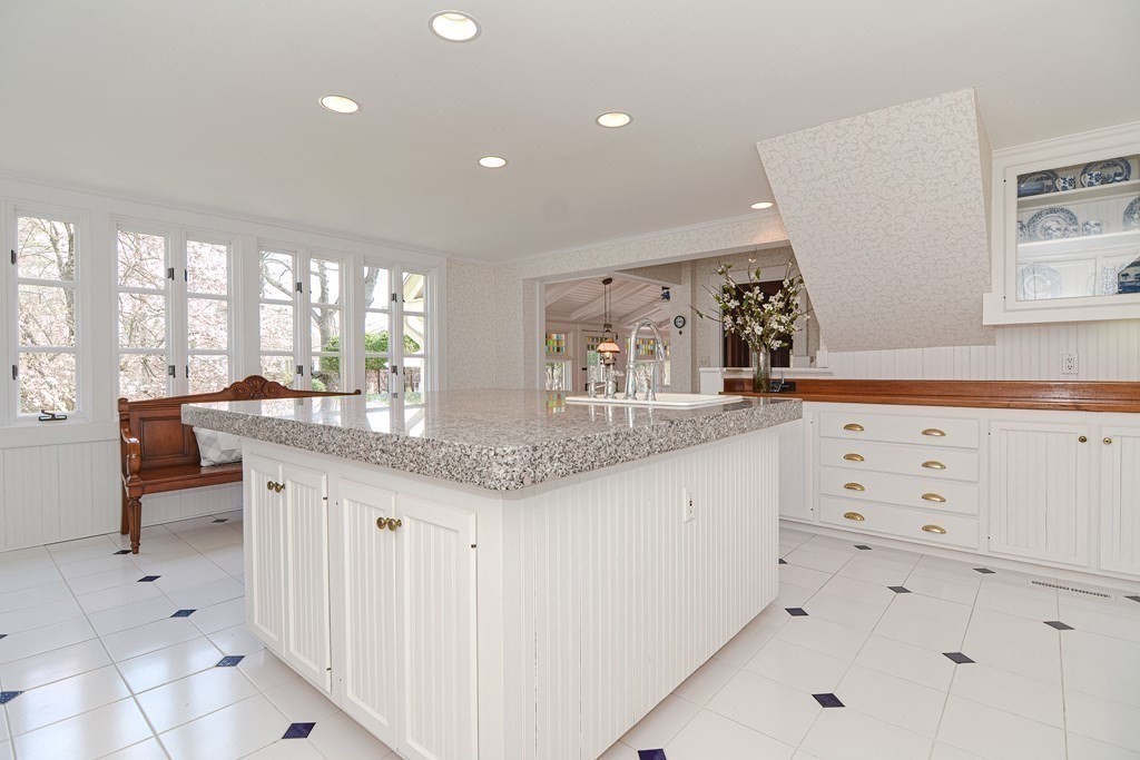 202 Paine Street Bellingham, MA 02019 - Photo 8 of 42 a kitchen with granite countertop white cabinets and white appliances