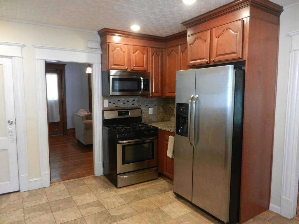 44 Howes Street Springfield, MA 01118 - Photo 8 of 19 a kitchen with stainless steel appliances granite countertop a refrigerator microwave and sink