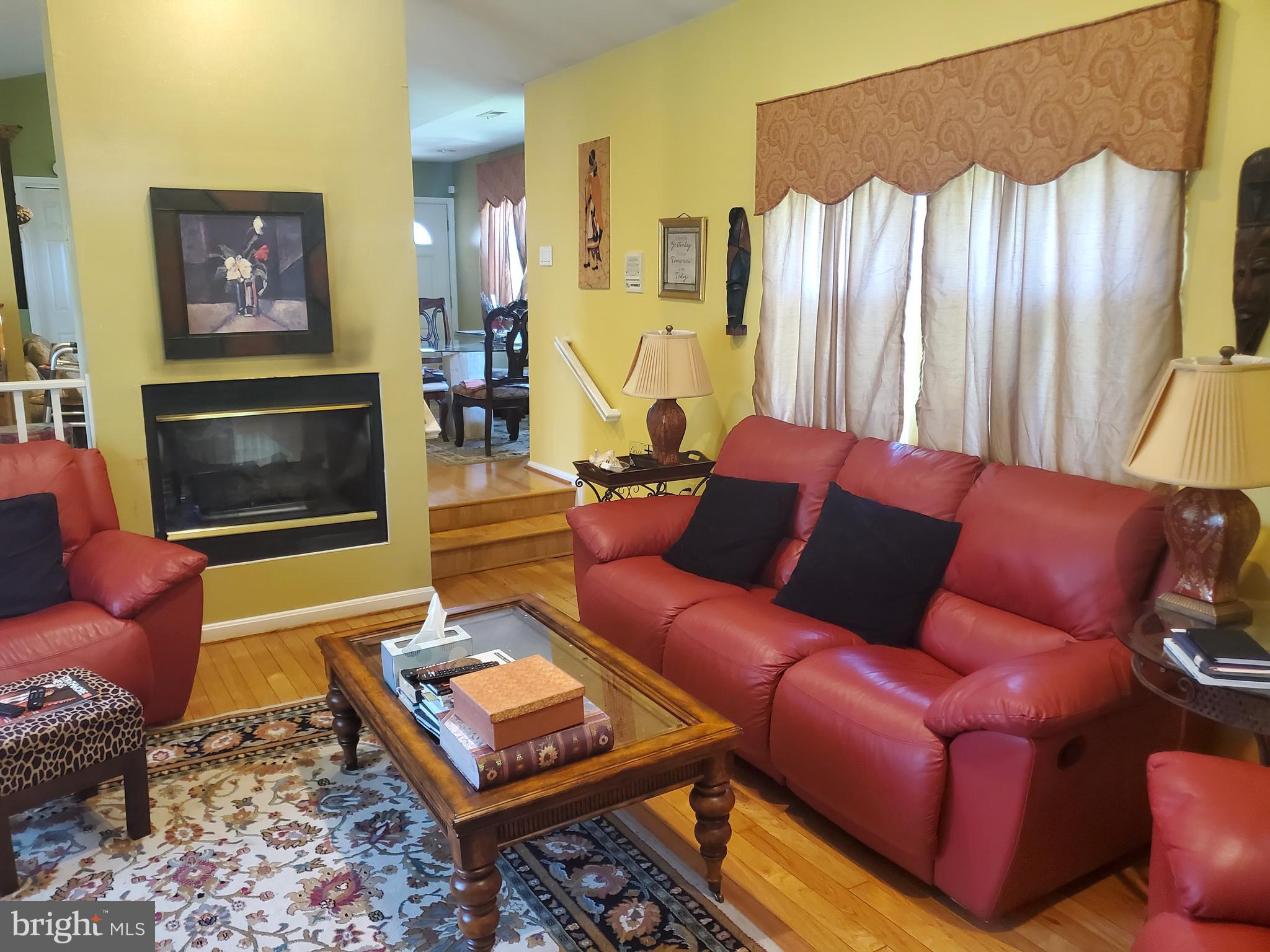 1514 Oakview Drive Silver Spring, MD 20903 - Photo 7 of 9 a living room with furniture a flat screen tv and a fireplace