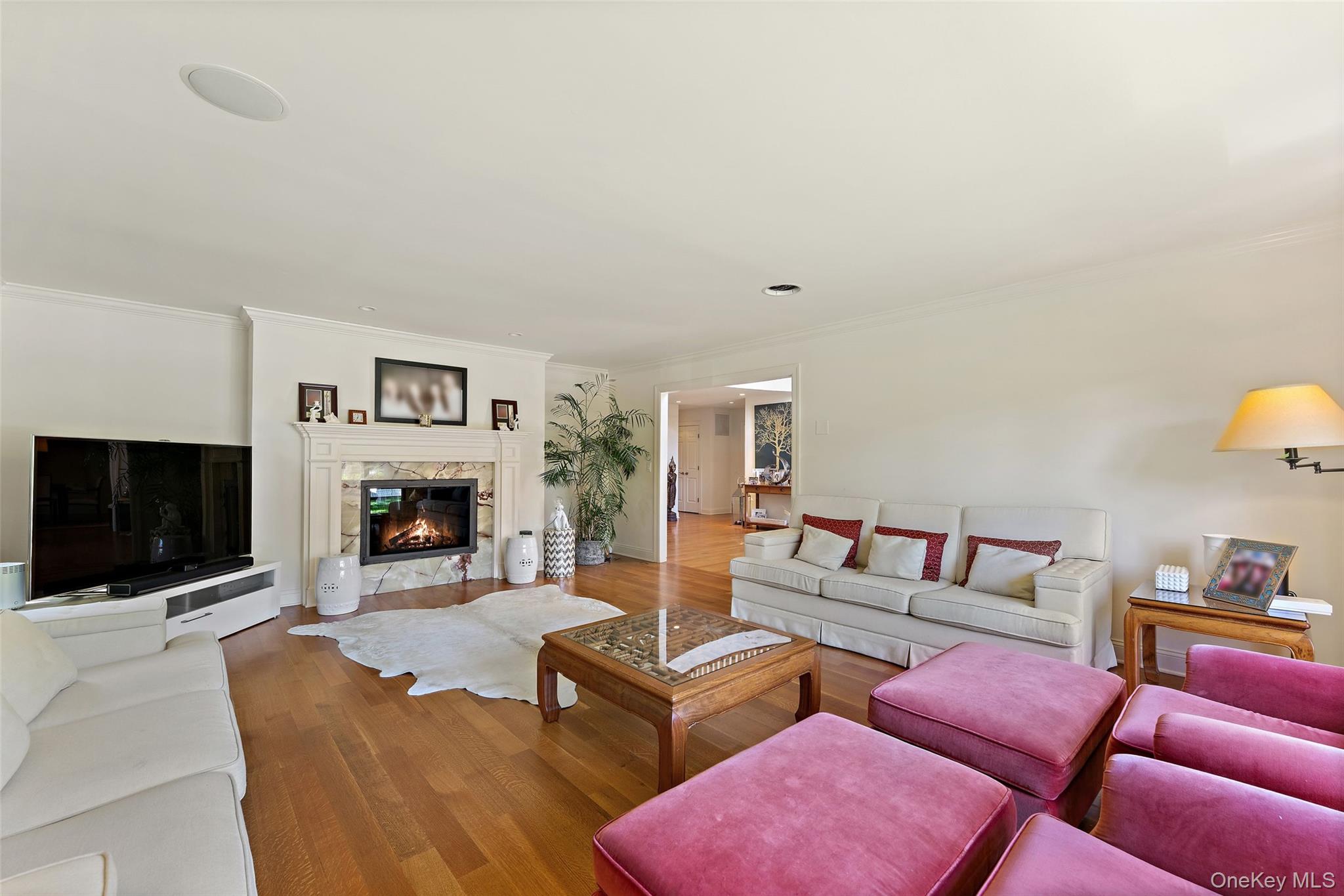6 Magnetti Circle Mamaroneck, NY 10543 - Photo 7 of 24 a living room with furniture a flat screen tv and a fireplace