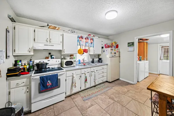 a kitchen with stainless steel appliances granite countertop a sink stove and cabinets