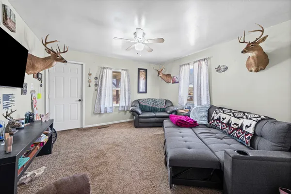a bedroom with furniture and a flat screen tv