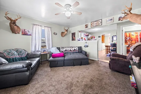 a living room with furniture and a chandelier