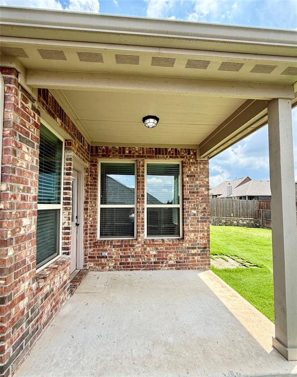 204 Flower Ridge Drive Fort Worth, TX 76108 - Photo 26 of 27 a front view of a house with a yard and table and chairs