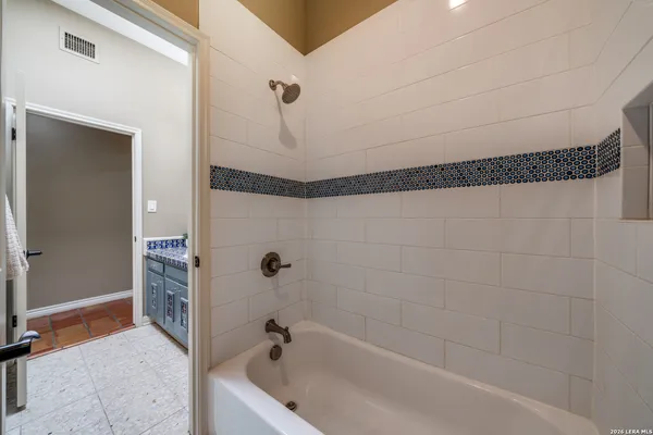 a bathroom with a bathtub and shower