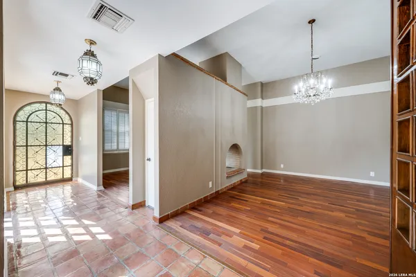 a view of a room with wooden floor and chandelier