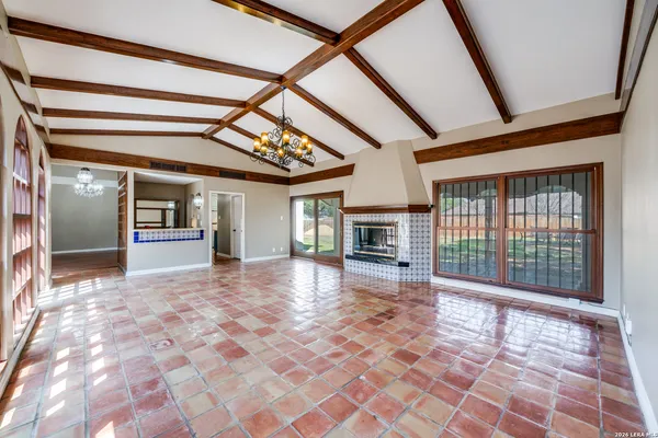 a view of empty room with wooden floor and fireplace