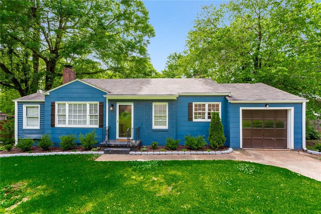 a view of a house with a yard and plants