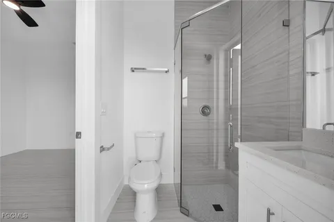 a bathroom with a shower a toilet and a sink