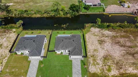 an aerial view of a house with a garden and swimming pool