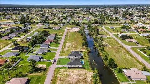 an aerial view of residential houses with outdoor space and swimming pool