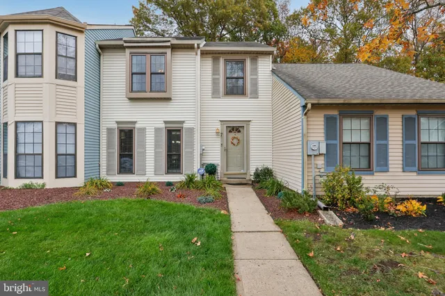 a front view of a house with a yard and porch