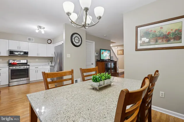 a dining room with furniture and wooden floor