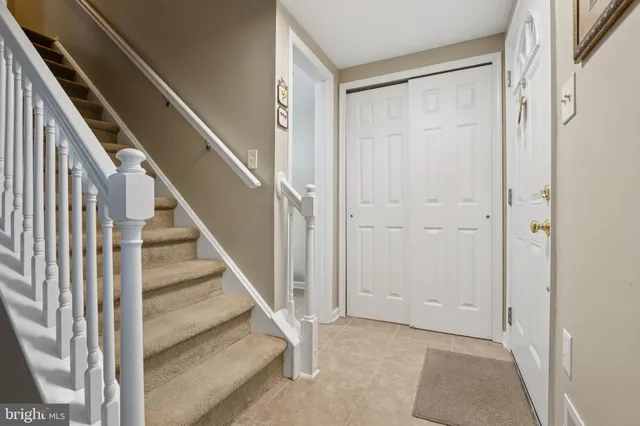 a bathroom with a granite countertop toilet sink and mirror