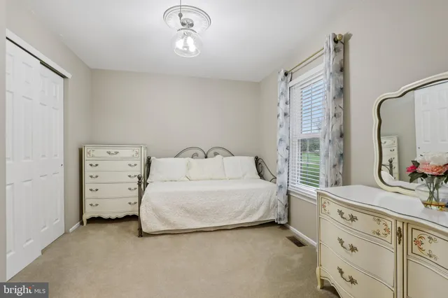 a bed room with a bed and a dresser